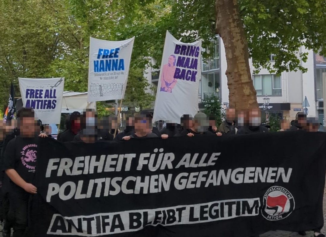 Schwarzes Fronttransparent beim Maja Aktionstag in Dresden mit der Aufschrift Freiheit für alle Politischen Gefangenen. Antifa bleibt legitim. im Hintergrund teile der Demo mit weitern Bannern wie Bringt Maja zurück.