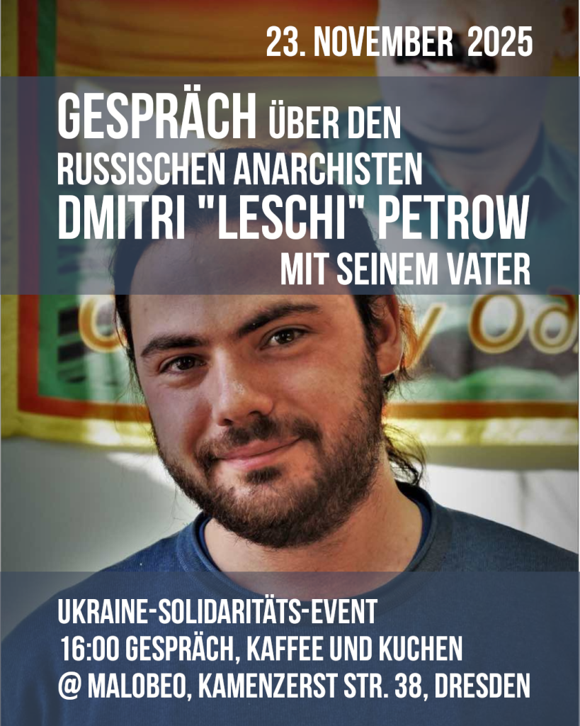 Dimitri Petrow in front of a flag with Öcalan Text Gespräch über den russischen Anarchisten Dmitri „Leshy” Petrow mit seinem Vater